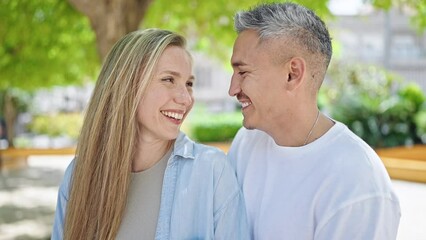 Poster - Man and woman couple smiling confident standing together at park