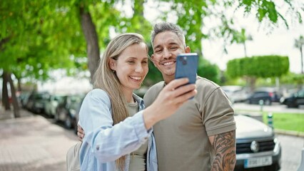 Poster - Man and woman couple smiling confident make selfie by smartphone at park