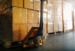 Package Boxes Wrapped Plastic on Pallets and Hand Pallet Truck. Cartons, Cardboard Boxes. Storehouse, Distribution, Supply Chain. Supplies Warehouse Shipping.	

