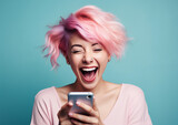 Fototapeta Tulipany - Happy young woman with colored hair and a smartphone