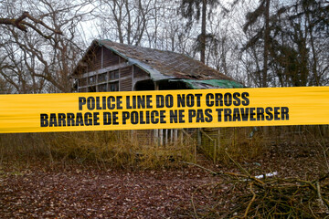 Poster - Bilingual Canadian police tape barricading an abandoned cabin in the wood