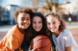 © Irina - Streetball concept. Portrait of three teenage basketball players with a basketball.