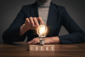 Poster - Bright light bulb in hand, idea search concept, creativity
