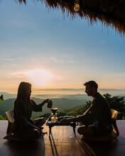 A Couple Of Men And Woman On Vacation In Thailand Waking Up With Drip Coffee In The Morning, With A Look At The Mountains Of Doi Chang Chiang Rai Thailand