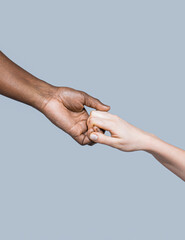 Wall Mural - Helping hand, Rescue, multiathnic people. Helping hands, Rescue gesture. Black and white human hands. African and caucasian hands. Giving a helping hand to another