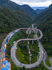 Wall Mural - Aerial view of Kelok 9 bridge at dusk. A popular bridge in Sumatra to commute between cities.