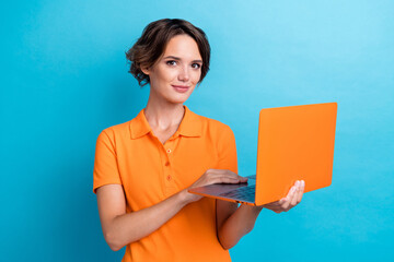 Wall Mural - Photo of cheerful positive girl dressed orange polo communicating apple samsung modern device isolated blue color background