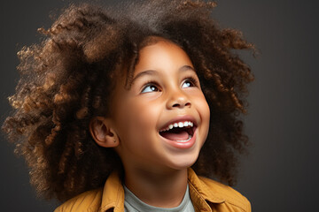 Wall Mural - Happy multinational little preschool girl in casual clothes on grey background