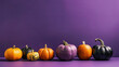 A group of pumpkins on a purple background or wallpaper