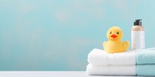 Cute Rubber Duck Next To The Soft Towels In The Bathroom Interior