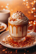 Pumpkin spice latte coffee drink tall glass with whipped cream topping on festive orange background, autumnal winter atmosphere, copy space