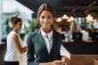 © tilialucida - A woman in a business suit holding a cell phone. AI image. Hotel receptionist.