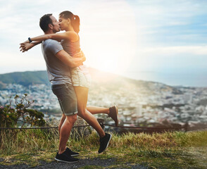 Wall Mural - Kiss, lift or happy couple hug in nature for outdoor date, love or trust with support, bond or freedom. Romantic man, care or woman excited by holiday vacation together to celebrate, relax or travel