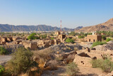 Fototapeta Miasto - Panorama of the old citadel of Tanuf houses built with straw and mud on the horizon surrounded by mountains. Oman.