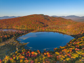 Wall Mural - aerial view of colorful autumn mountain forest and pond