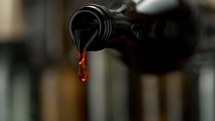 Wall Mural - Pouring Red Wine from a Bottle into Glass. Close-up.