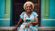 Cuban elderly woman with her flowered clothes happy enjoying an afternoon in Havana, Caribbean lifestyle, flowers and intense colors