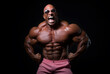 © fraudiana - Shirtless bodybuilder with sunglasses flexing his muscles on a black background