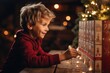 Cute smiling little girl opens an advent calendar. Time for Christmas gifts and miracles. Family traditions for Christmas. Girl enjoys Christmas gifts
