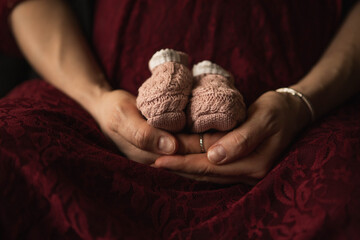 hands holding shoes pregnancy.jpg