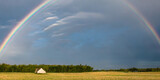 Fototapeta Tęcza - lightening and rainbow on sky above field canada 