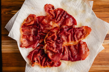 Wall Mural - Crispy Fried Prosciutto Draining on Paper Towels: Thinly sliced prosciutto ham fried until crunchy and draining oil on kitchen roll