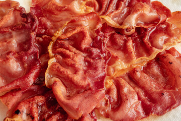 Wall Mural - Crispy Fried Prosciutto Draining on Paper Towels: Thinly sliced prosciutto ham fried until crunchy and draining oil on kitchen roll