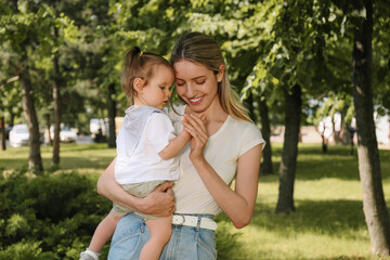 happy mother with her daughter walking in park