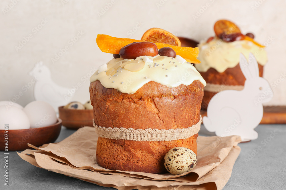 Easter cakes with animal figures and eggs on blue grunge table near white wall
