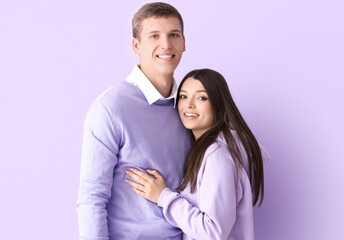 Poster - Happy young couple hugging on lilac background