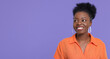© New Africa - Portrait of happy young woman on purple background. Space for text