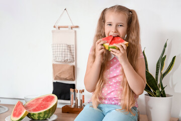 Sticker - Little girl with fresh watermelon sitting at table in kitchen