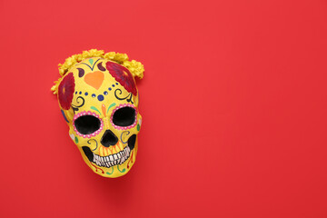 Sticker - Painted human skull for Mexico's Day of the Dead (El Dia de Muertos) with flowers on red background