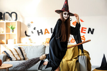 Poster - Little girl dressed for Halloween as witch with broom at home