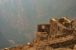 Pert of Machu Picchu ruins above big canyon
