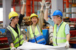 © offsuperphoto - workers team raise hands up for success work or project in the factory