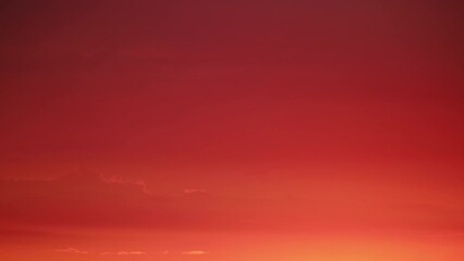 Wall Mural - The fading light of the sunset casts a warm and nostalgic glow over the cloudy landscape.