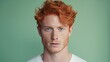 Handsome elegant sexy Caucasian man with perfect skin and red hair, on a light green background, banner, close-up.