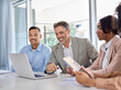 © insta_photos - Happy diverse multiethnic young and older business people employees team working in teamwork developing digital strategy presentation at group meeting using laptop computer in office boardroom.