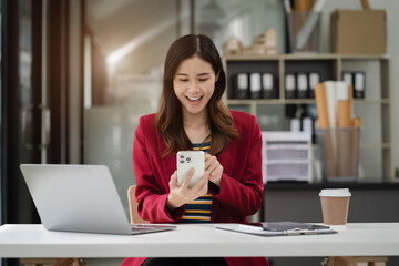 Business women holding smartphone with blank screen, close-up of hands. Space for text.