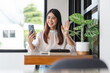 © snowing12 - Businesswomen use smartphone to greeting with colleague in video call and working in outside office