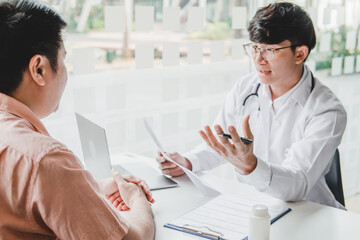 Wall Mural - Doctors and patients consulting and diagnostic examining sit and talk. At the table near the window in the hospital medicine concept