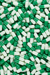 Wall Mural - White green capsule top view. Pills and drugs