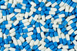 Blue white capsules top view. Pills and drugs. Pharmaceutical Industry. The medicine concept