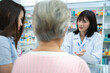 © Jestercine - Young Asian pharmacist talking with customer at pharmacy counter. She tells customers about drug information at the pharmacy.