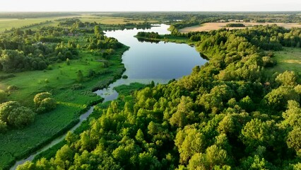 rural landscape with country houses. lake in countryside on sunset, aerial view. green nature at lak