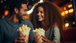 © Kateryna - A couple in love sharing popcorn in a dimly lit cinema, blurred background