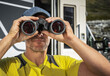 © Tomasz Zajda - Spotting Wildlife Using Binoculars While Staying in Front of RV Camper Van