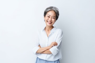 Portrait of Asian senior woman posing on white wall background.