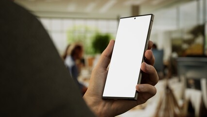 CU 30s Caucasian male holding a phone in vertical orientation, green screen